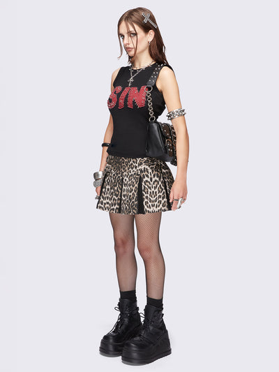 Black vest top featuring a "SIN" red patch with safety pins and studded trim details. 