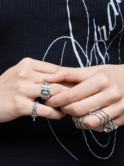 Silver set of 4 rings with cross designs.