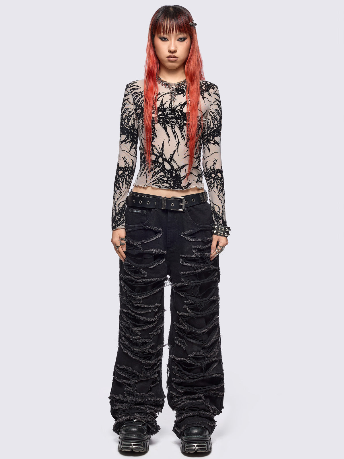 Black baggy jeans featuring distressed cut-out slashed legs.