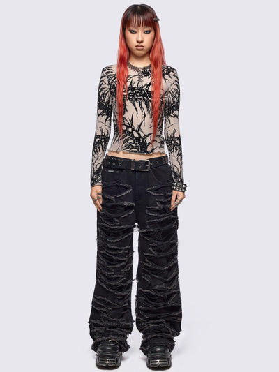 Black baggy jeans featuring distressed cut-out slashed legs.