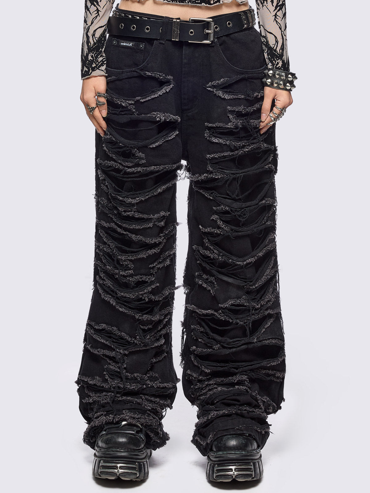 Black baggy jeans featuring distressed cut-out slashed legs.