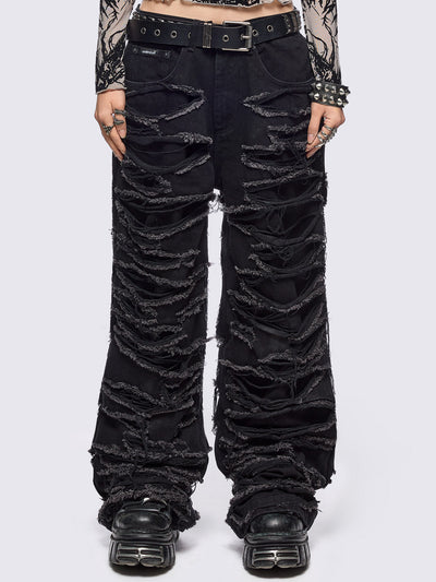 Black baggy jeans featuring distressed cut-out slashed legs.