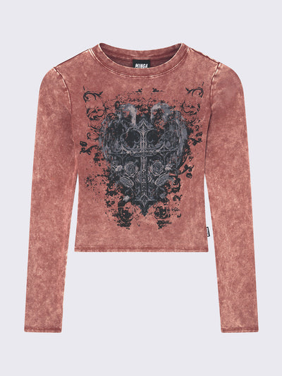 Long sleeve top in washed terracotta red with winged cross front graphic print.