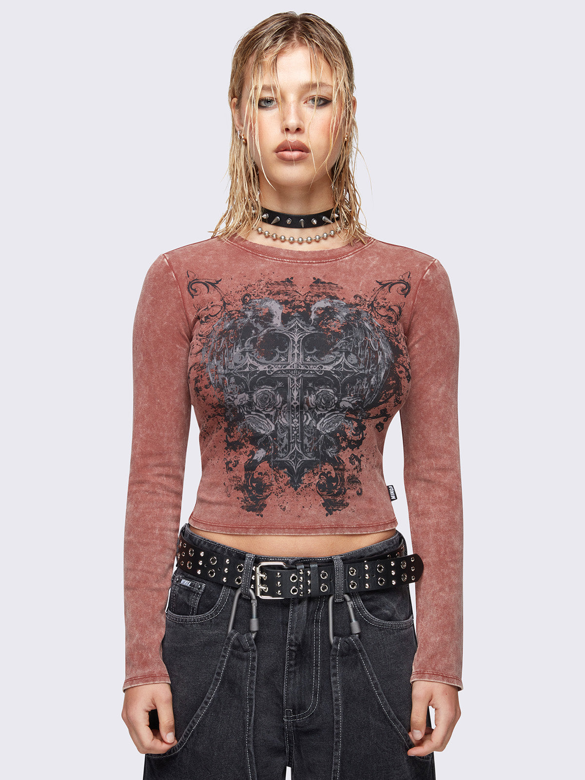 Long sleeve top in washed terracotta red with winged cross front graphic print.