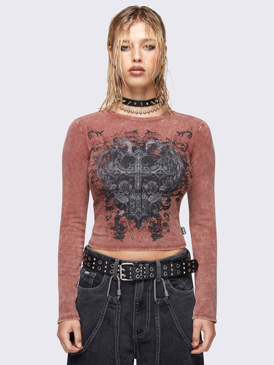 Long sleeve top in washed terracotta red with winged cross front graphic print.