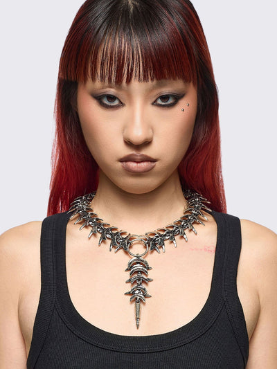 Silver chunky charm necklace featuring a spine design and spike pendant.
