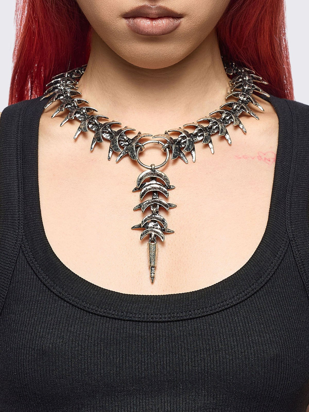 Silver chunky charm necklace featuring a spine design and spike pendant.