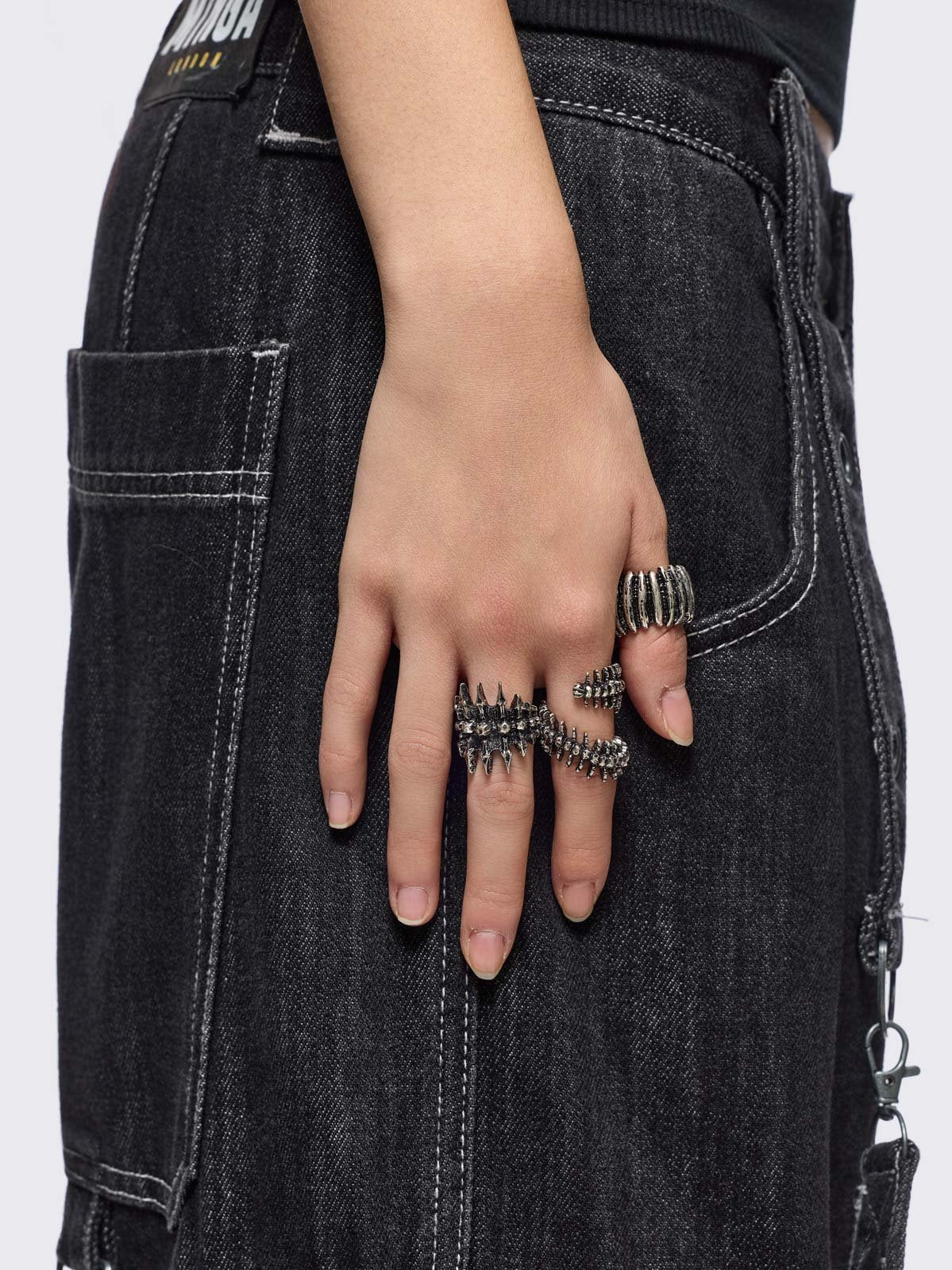 Set of 5 silver rings with centipede, spine and spike designs. 