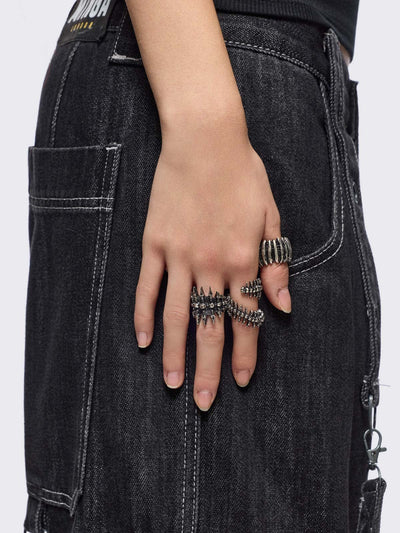 Set of 5 silver rings with centipede, spine and spike designs. 