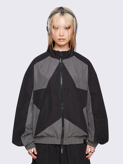 Black and grey color-block windbreaker with bold star graphic and oversized boxy fit— edgy, utility-inspired streetwear style.