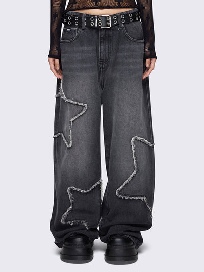 Baggy jeans in washed black with frayed star patches and wide leg fit. 