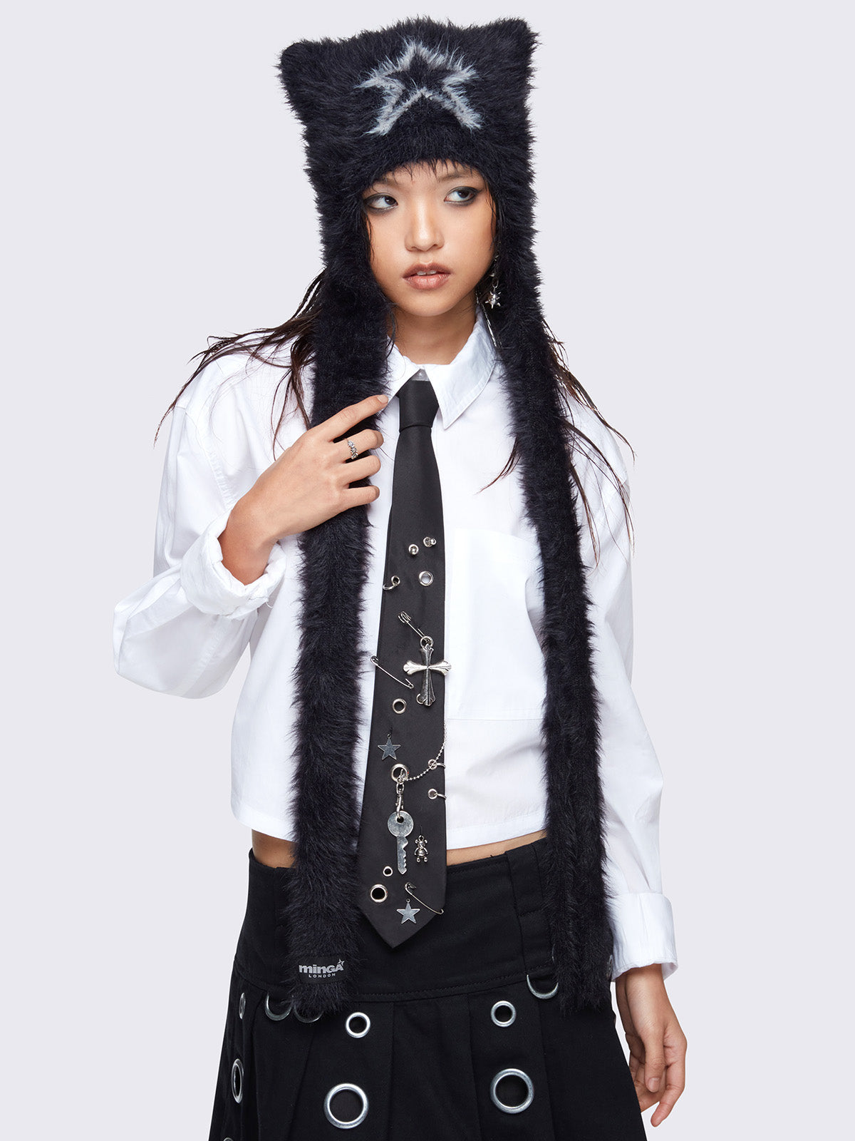 Black faux fur beanie hat with long strap featuring a star front design in light grey.