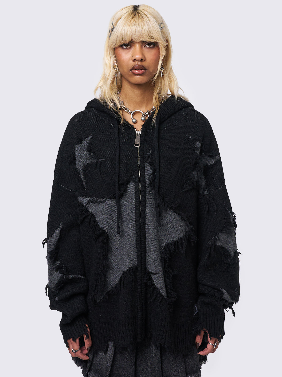 Hooded knit cardigan in black with frayed stars design in grey and distressed rib details.