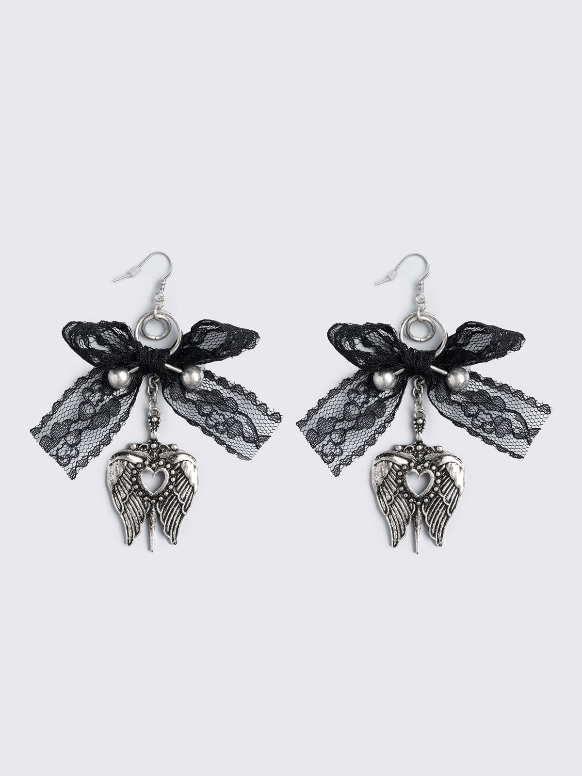 Silver dangle earrings with winged heart pendant and back lace bows and piercing details.