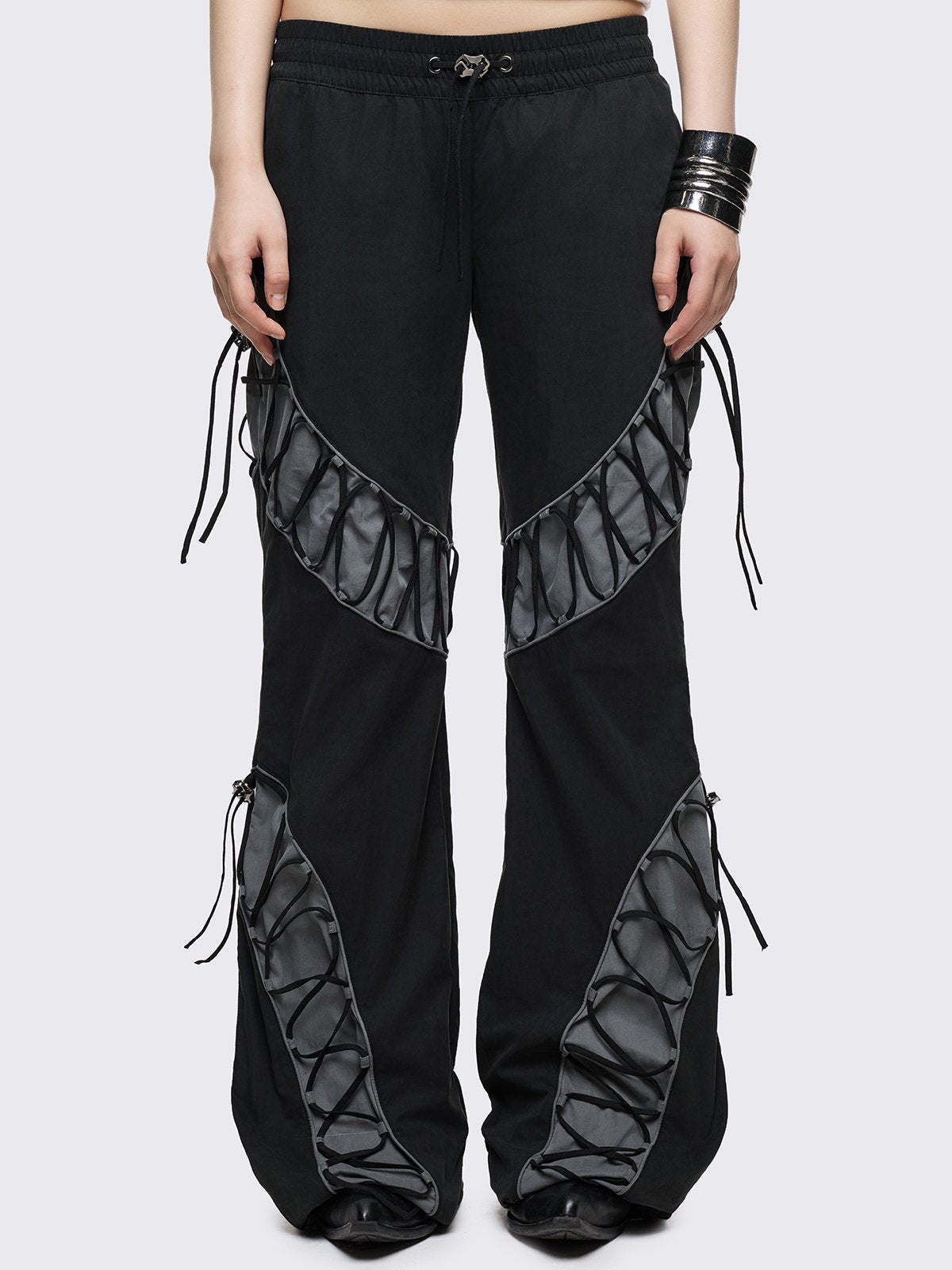Black parachute baggy flared pants with grey panels with lace up. 