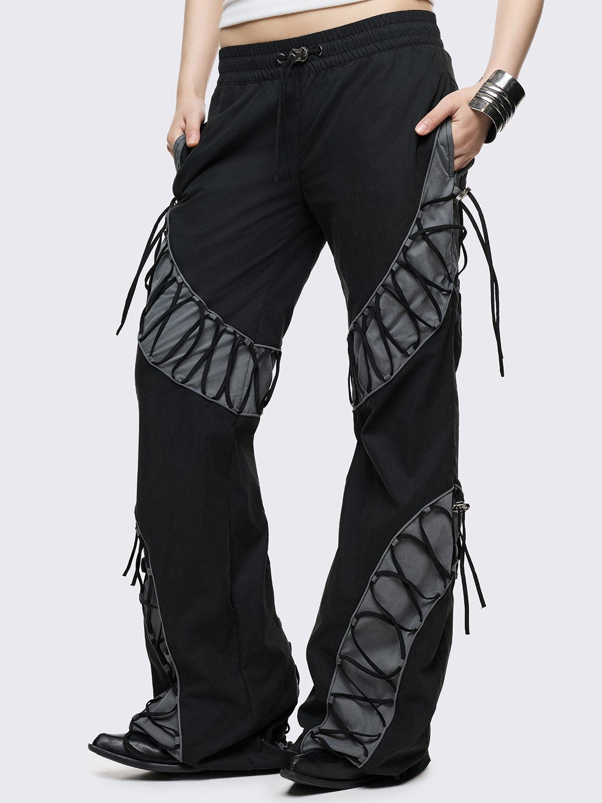 Black parachute baggy flared pants with grey panels with lace up. 