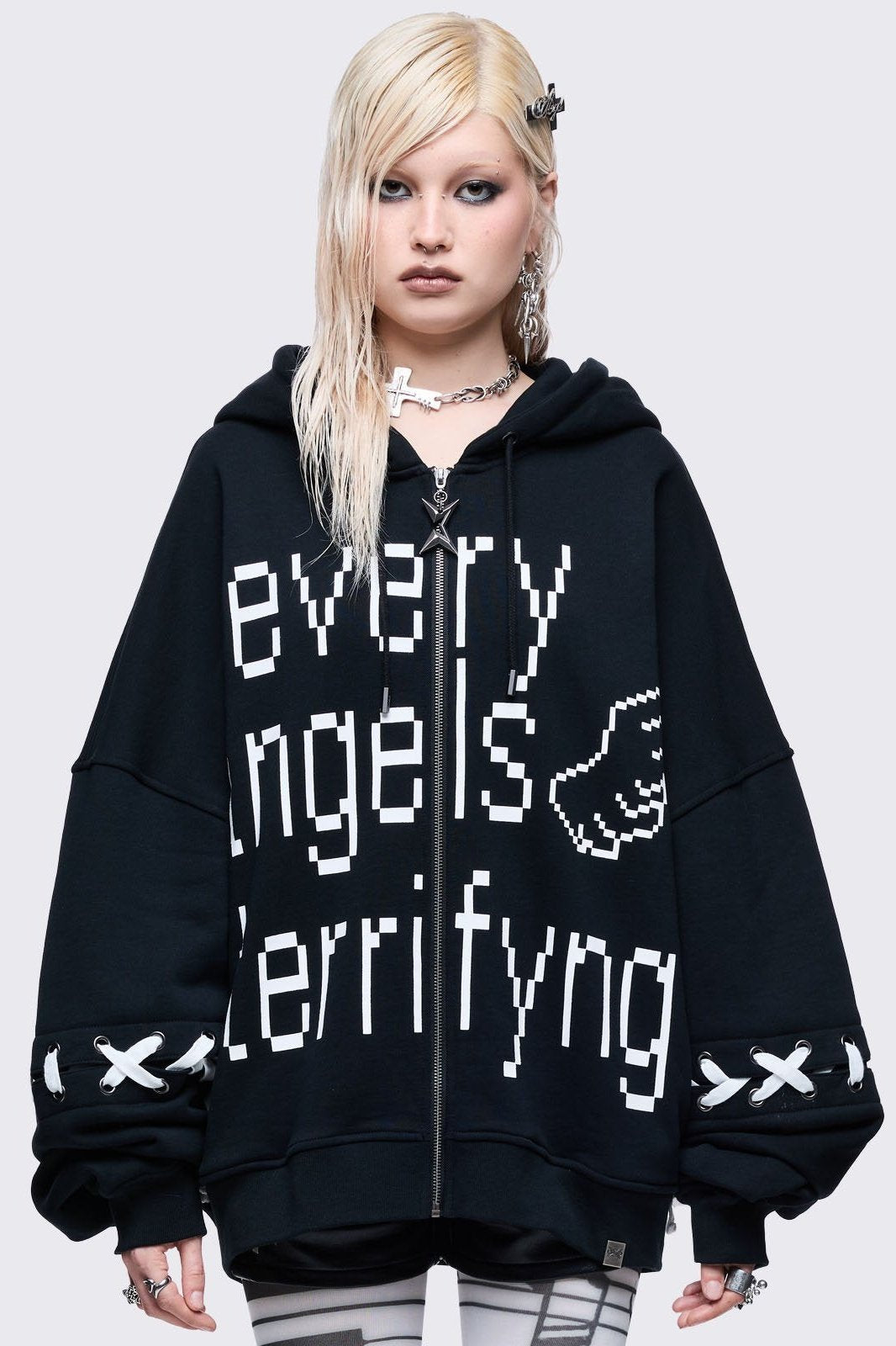 Black zip up hoodie jacket with "Every angels terrifying" graphic print and white lace-up details.