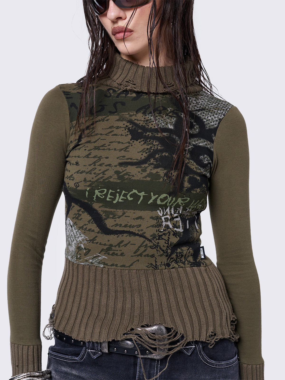 Khaki high-neck long sleeve top with a grunge graphic print on the front, featuring distressed chunky ribbed trims.