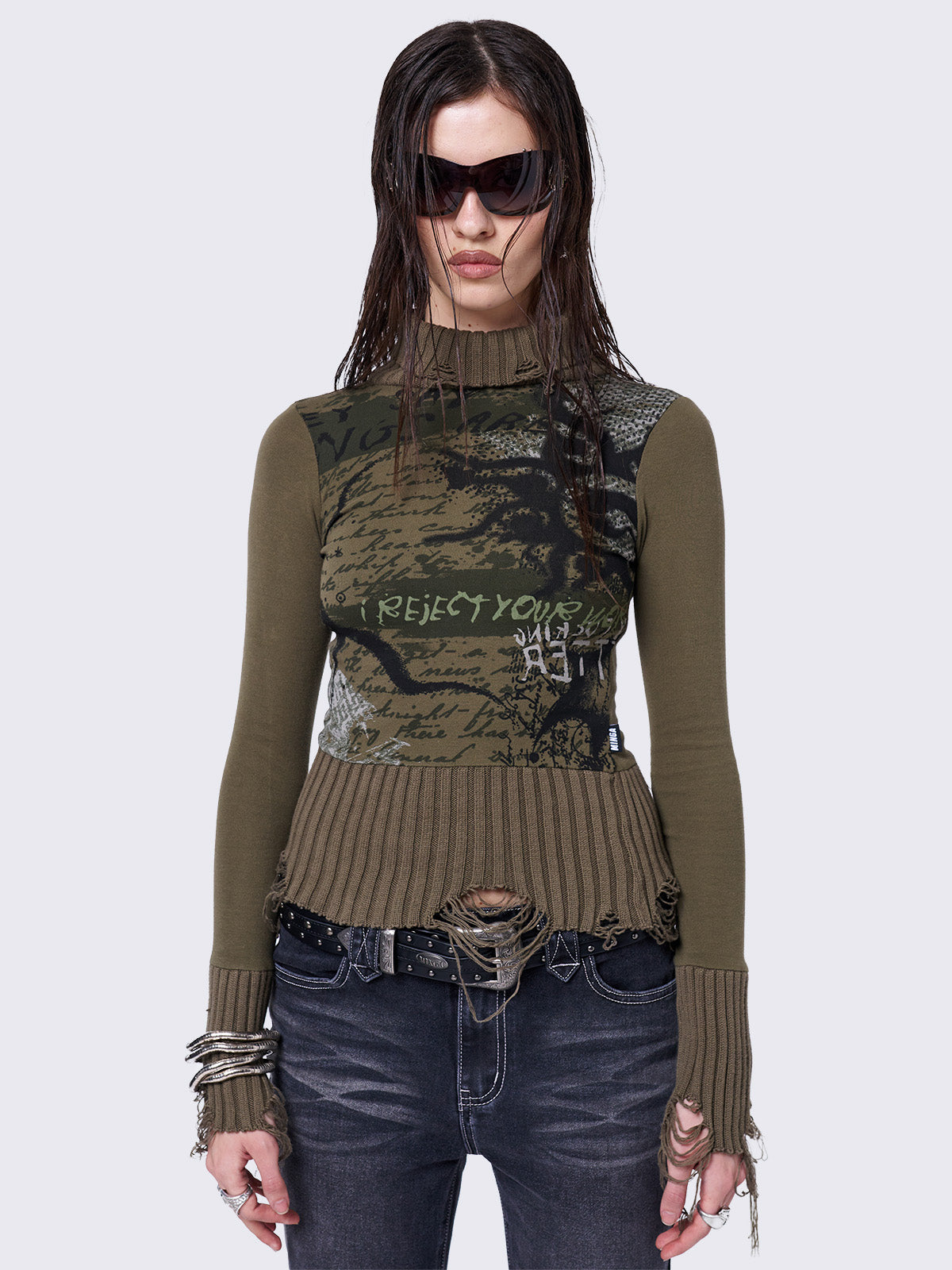 Khaki high-neck long sleeve top with a grunge graphic print on the front, featuring distressed chunky ribbed trims.