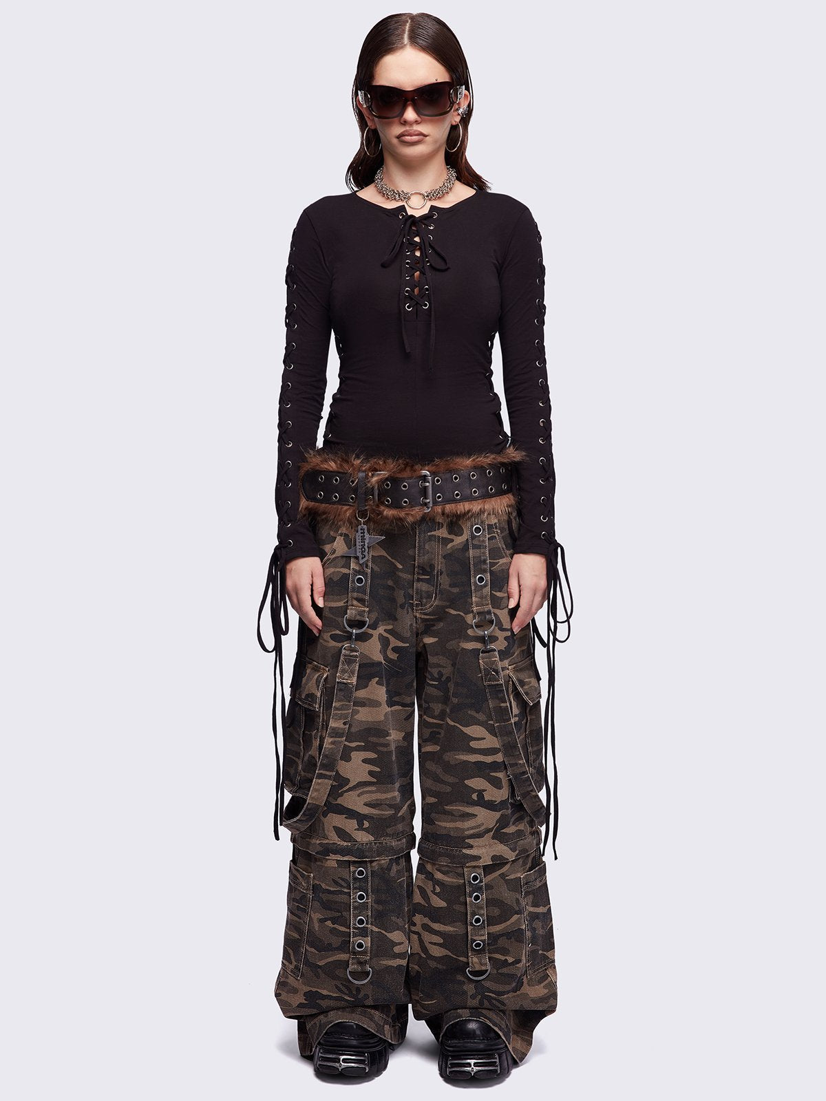 Camo multi pocket cargo jeans featuring a detachable-leg with zipper and all over straps and D-rings details.