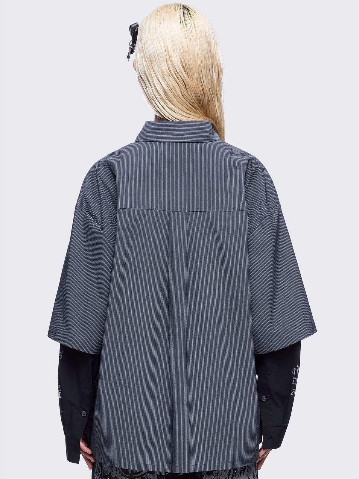 Two-piece gothic shirt ensemble featuring a pinstriped outer layer with a distressed text print, over black long sleeves detailed with white gothic text and imagery.