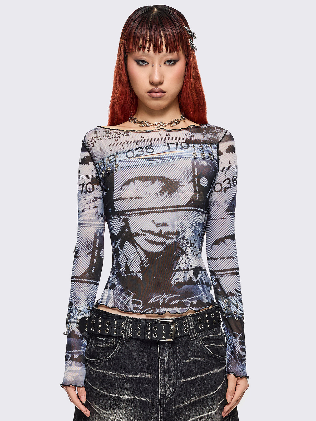 Black and grey graphic mesh crop top with cut-out and safety pins.