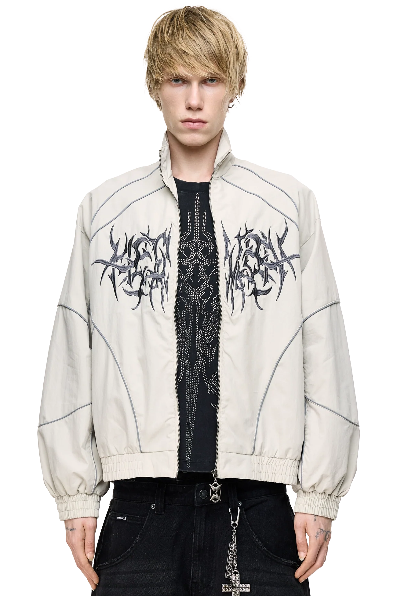 Grey windbreaker jacket with reflective piped seams, sigilism embroidery, zip pockets and relaxed fit.