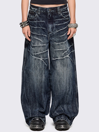 Blue washed wide leg baggy jeans featuring a grey overdye and distressed wrinkle-effect.