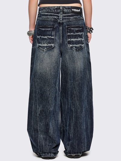 Blue washed wide leg baggy jeans featuring a grey overdye and distressed wrinkle-effect.
