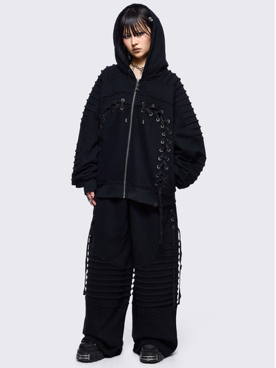 Black zip up hoodie jacket featuring a moto pintuck panels and front lace corset details. 