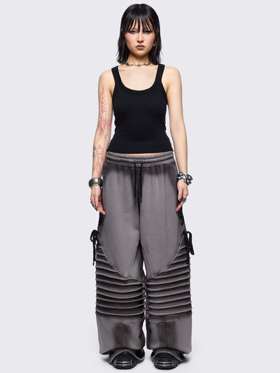 Grey washed wide leg sweatpants featuring moto pintuck panels, lace-up details and black fade out.
