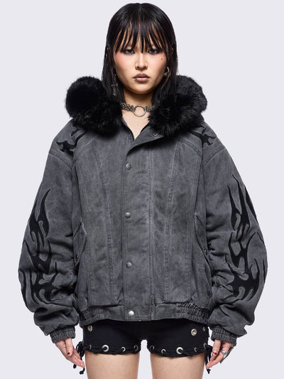 Grey washed denim bomber jacket featuring black sigilism patches and black faux fur hood.