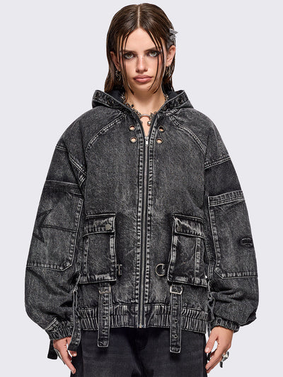 Black acid washed denim bomber jacket featuring boxy oversized fit, front flap pockets, buckle straps, eyelets, metal hardware and seams details.
