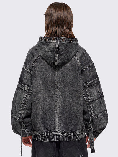 Black acid washed denim bomber jacket featuring boxy oversized fit, front flap pockets, buckle straps, eyelets, metal hardware and seams details.