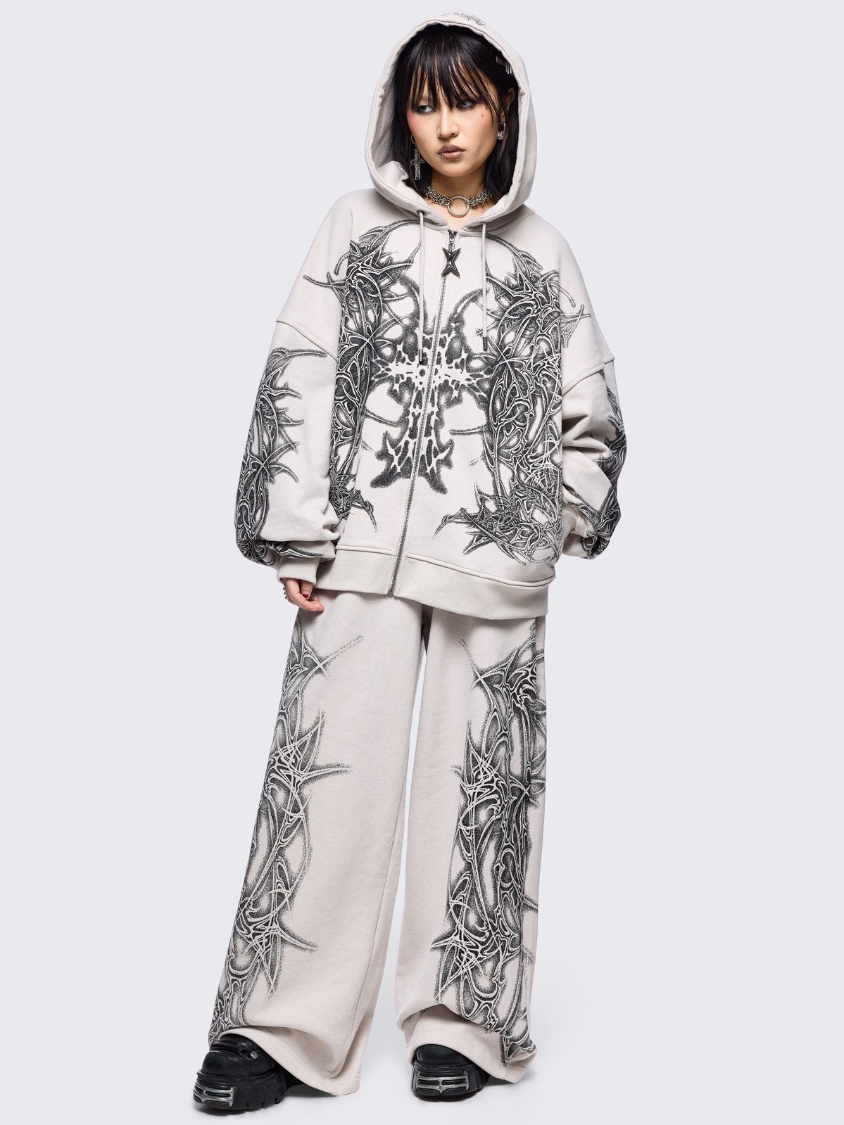 Grey wide leg sweatpants featuring a black sigilism graphic side print.