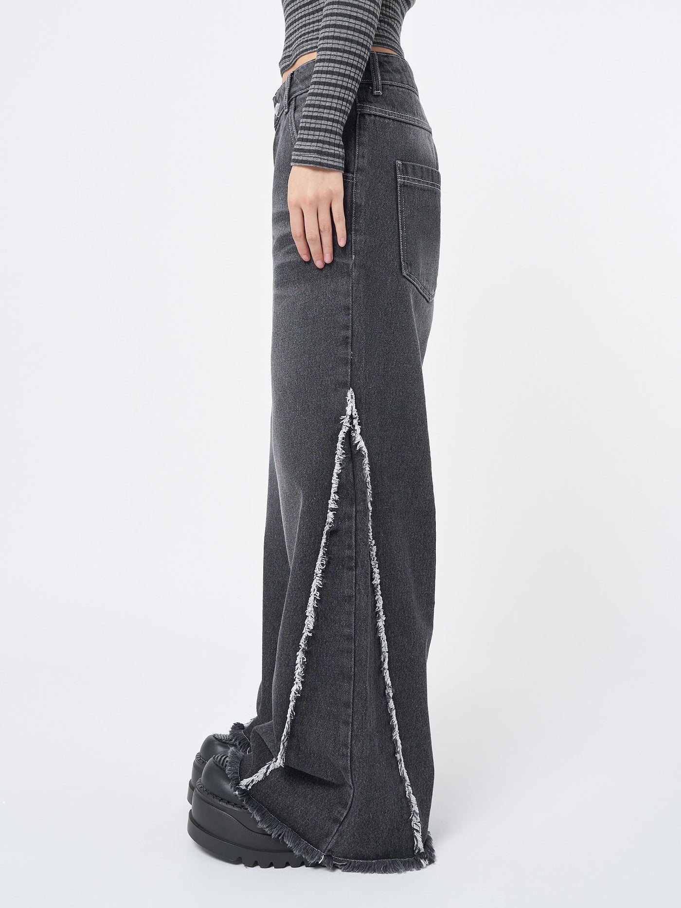 Wide leg jeans in washed black with contrast stitching in white and distressed side details