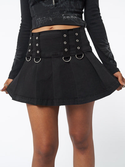Pleated mini skirt in black with grommet eyelet strip and D-ring details